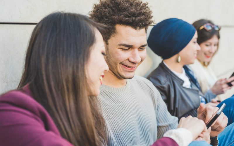 Multiracial group young people using smart phone